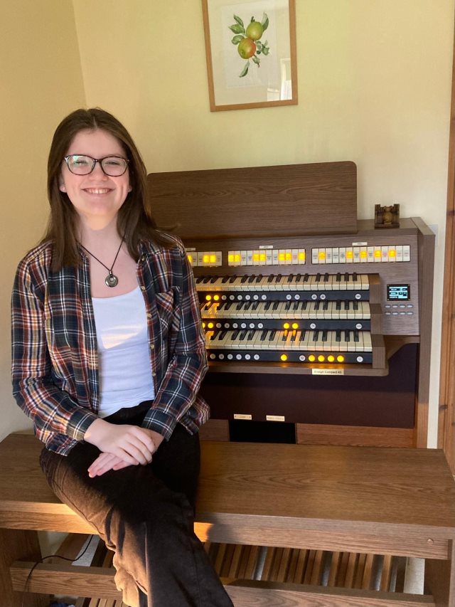 Phoebe Burgess next her new Viscount 3 manual Organ