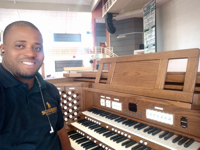Ibok sitting at Viscount organ console in Nairobi Kenya.