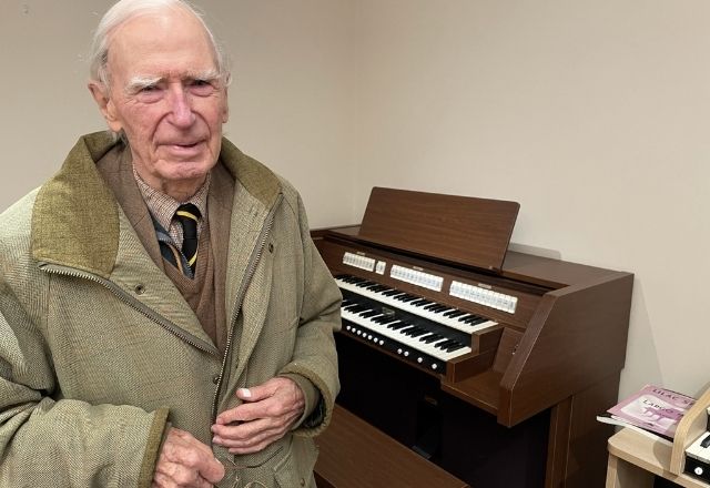 Practice organ for Viscount Organs oldest customer. John in front of his Jubileum 232 instrument.