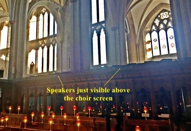 Organ speakers behind choir screen under the windows